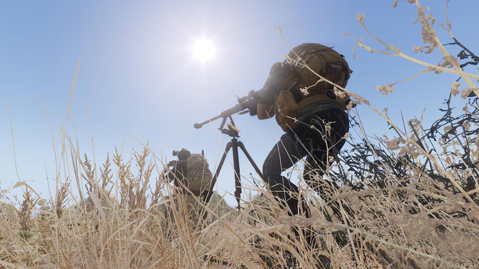A sniper resting a rifle on a tripod.